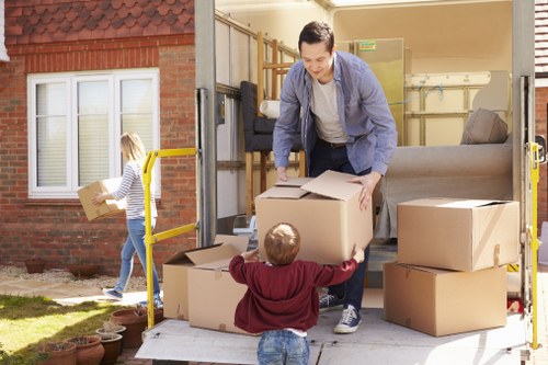 Professional moving team organizing boxes and furniture in Kensington