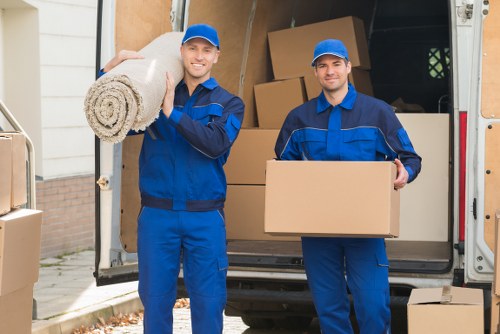 Kensington moving service unloading furniture near a property entrance