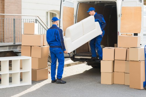 Professional movers handling furniture in a Kensington townhouse