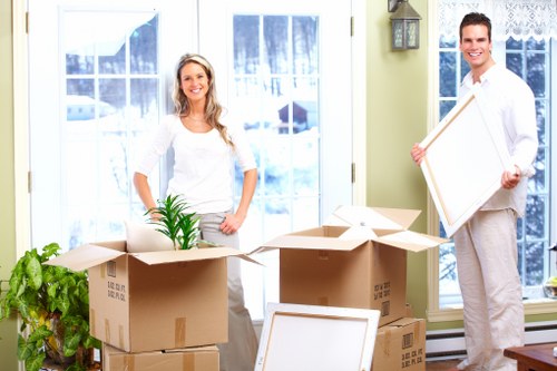 Local moving team handling packing and labeling in a Kensington property