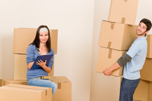 Removal crew handling packed boxes and furniture during transport